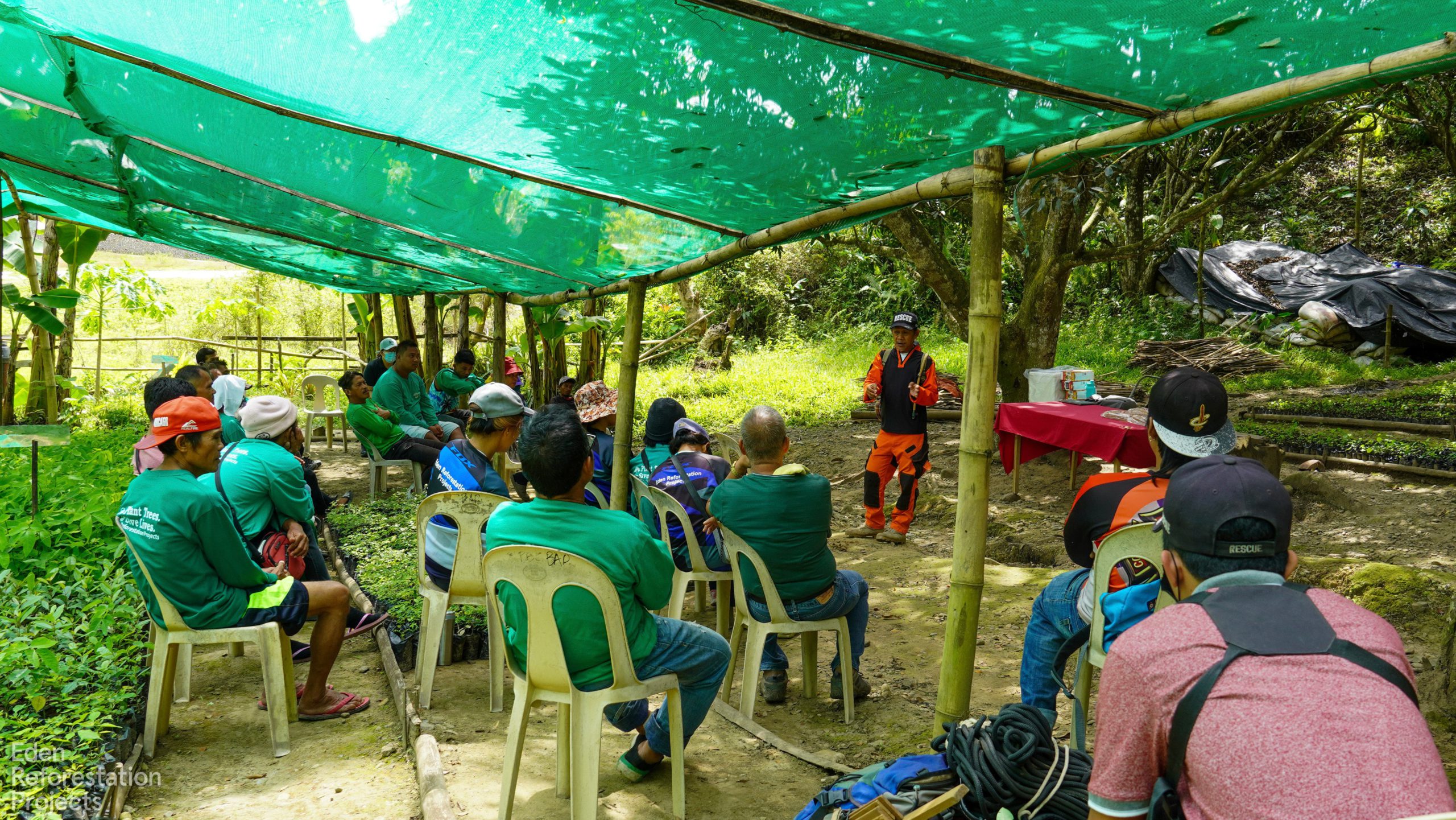 Workers having a meeting under bamboo structure
